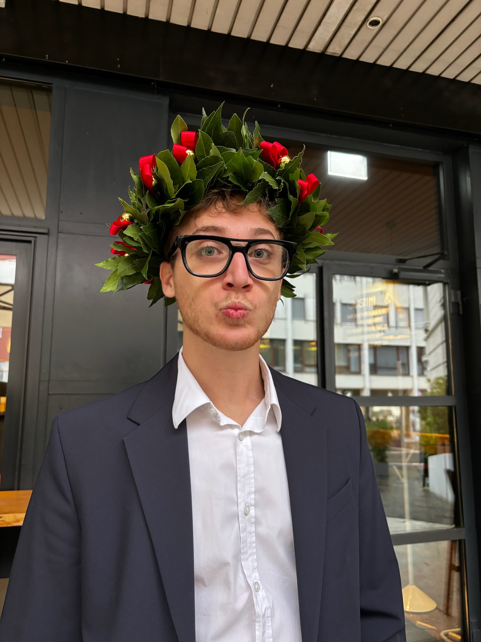 Andrea wearing a laurel crown after graduation